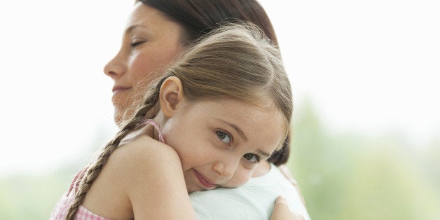 Close up of daughter hugging mother