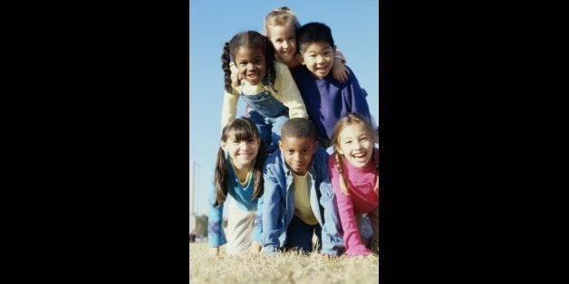 Portrait of a group of children making a human pyramid