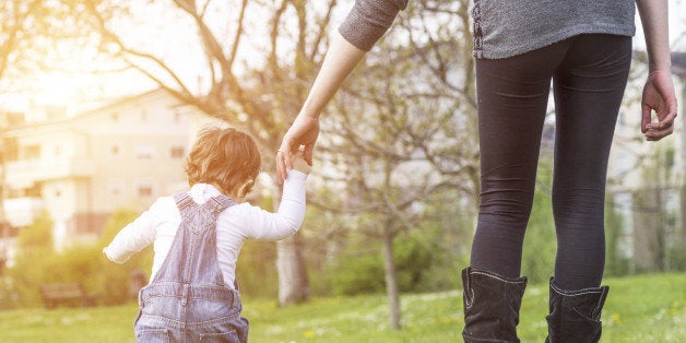 mother teaching her daughter how to walk