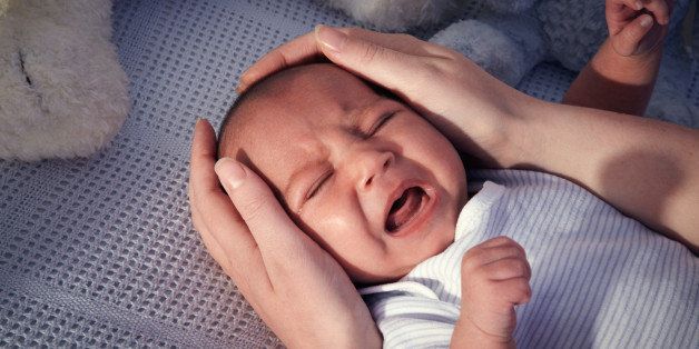 Baby boy in crib crying