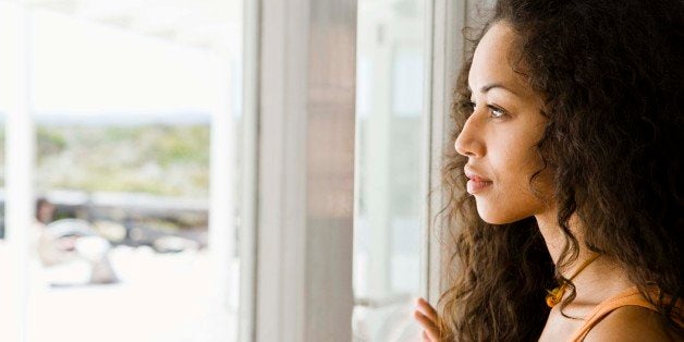 Woman daydreaming at window