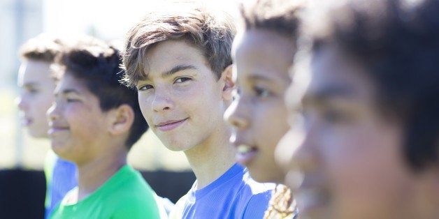 Boys soccer team, aged 12-14, in a line up before a game