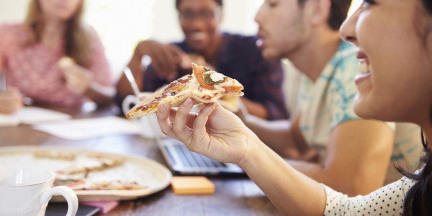 Business People Having Meeting Around Table And Eating Pizza