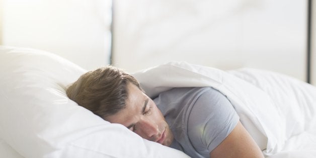 Young man sleeping in bed