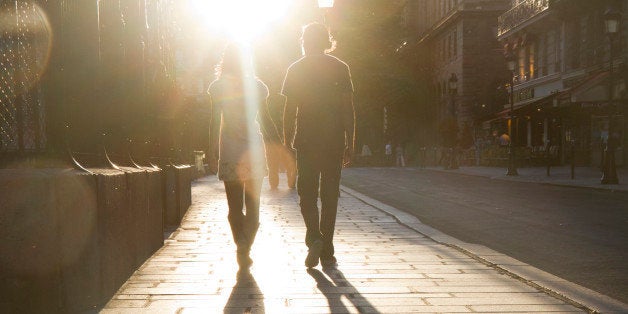 France, Paris, Young couple walking in street