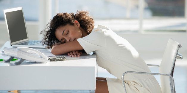 Woman napping with her head resting on desk