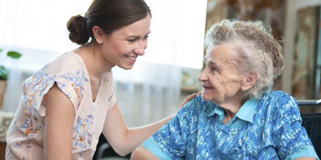 Elderly woman on wheelchair with a nurse