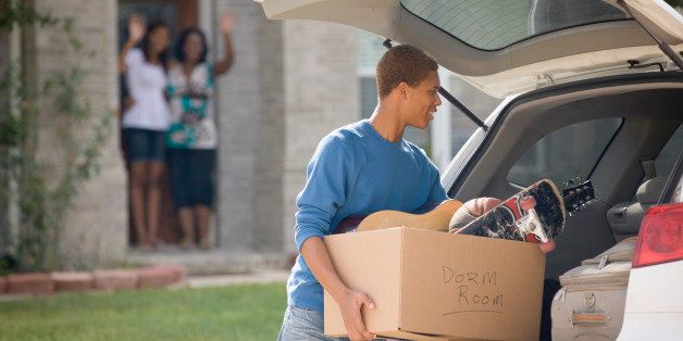 Mixed race teenager loading car for college