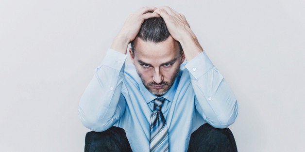 Portrait of an exhausted business man in studio.