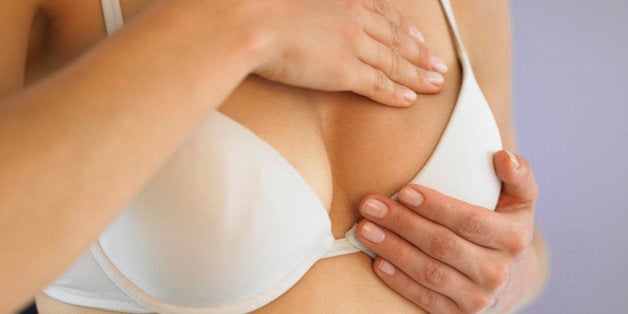 Woman doing breast self exam