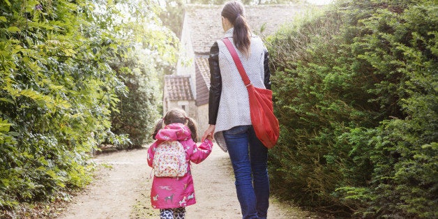 Mother and daughter walking to school.