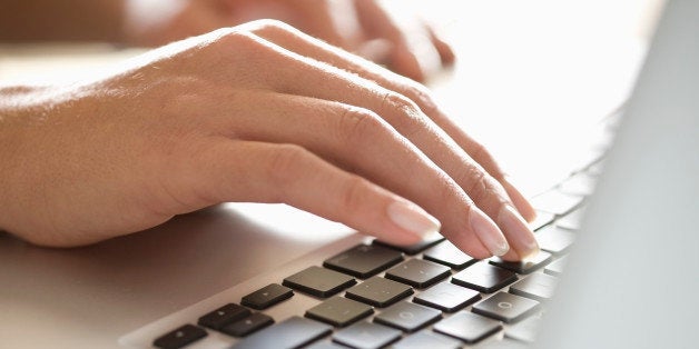 Close up of woman typing on laptop