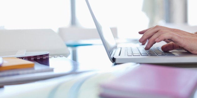 Businesswoman using laptop at desk