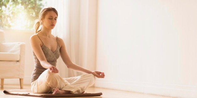 USA, New Jersey, Young woman practicing yoga