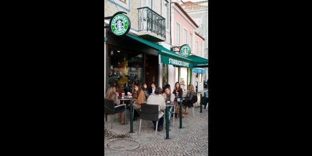 LISBON, PORTUGAL - DECEMBER 19: people having a break at Starbucks coffee esplanade on December 19, 2011 in Lisbon, Portugal. The largest coffeehouse company in the world with 18,887 stores