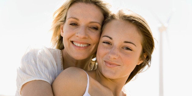 Portrait of mother hugging daughter