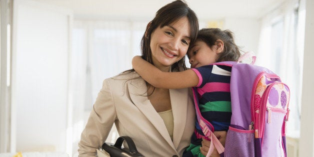 Hispanic daughter hugging mother as she leaves for work