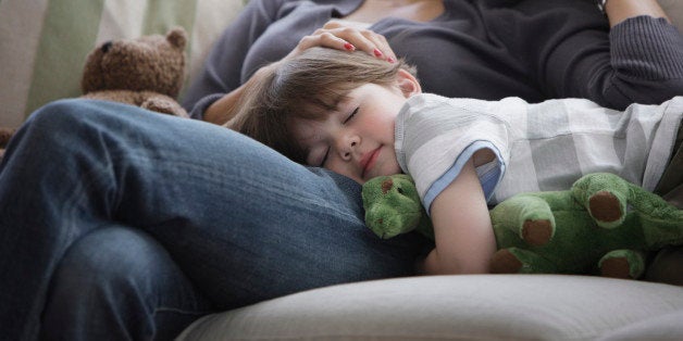 Close up of mother and son napping on sofa