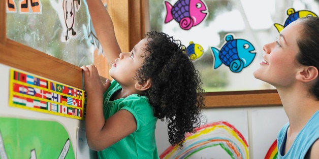 School Girl Decorating Window