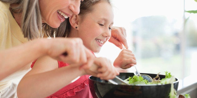 Grandmother and granddaughter preparing salad