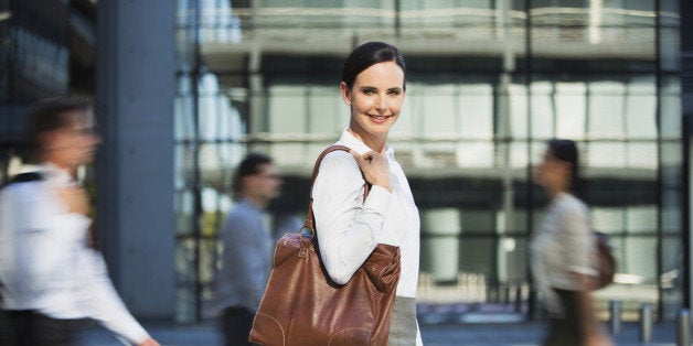 Smiling businesswoman outside urban building