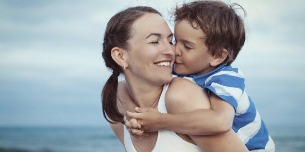 Portrait of happy mother and son at sea, outdoor