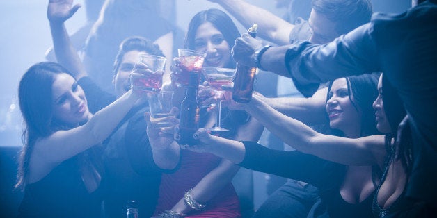 Friends toasting each other in nightclub