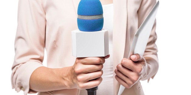 TV presenter holding a microphone close-up. Isolated on white background.