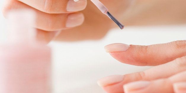 Woman painting fingernails
