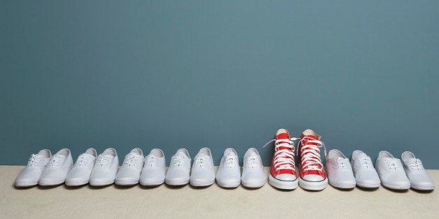 Pair of shoes in row against wall