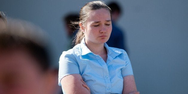 A girl who declined to give her name reacts at the conclusion of a press conference with Oregon Governor Kate Brown in Roseburg, Oregon on October 2, 2015. Ten people have been confirmed dead in a mass shooting at Umpqua Community College by a an unconfirmed gunman who used protective clothing and multiple weapons, all of which were purchased legally. AFP PHOTO/JOSH EDELSON (Photo credit should read Josh Edelson/AFP/Getty Images)