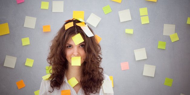 secretary overwhelmed with sticky reminder notes