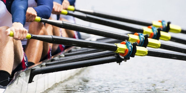 Close up of a men's quadruple skulls rowing team, seconds after the start of their race