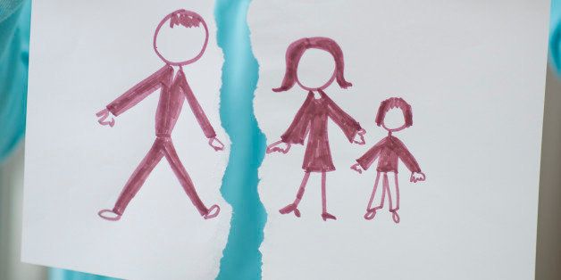 Girl holding drawing of split family