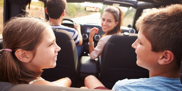 Parents Taking Children On Trip In Open Top Car