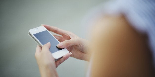 Young woman using smart phone, close-up