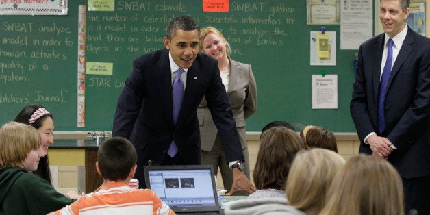 President Barack Obama, left, and U.S. Education Secretary Arne Duncan, right, visit Susan Yoder's, center, science class at Parkville Middle School and Center of Technology, in Parkville, Md., Monday, Feb., 14, 2011. (AP Photo/Carolyn Kaster)