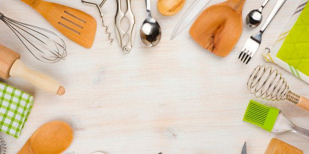 Kitchen utensils and cutlery background with copy space in center