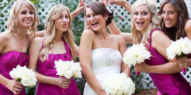 Bride posing with her bridesmaids.