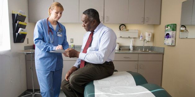 Female nurse talking to male patient
