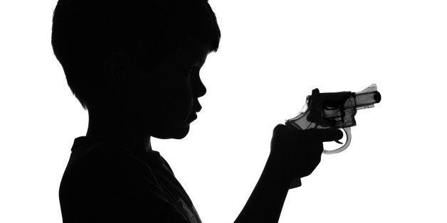B&W Silhouette of a boy holding a toy gun