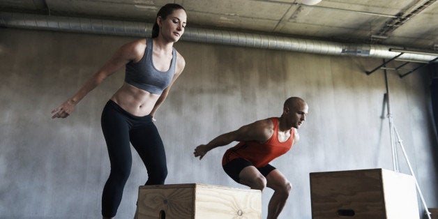 Shot of a young man and woman working out