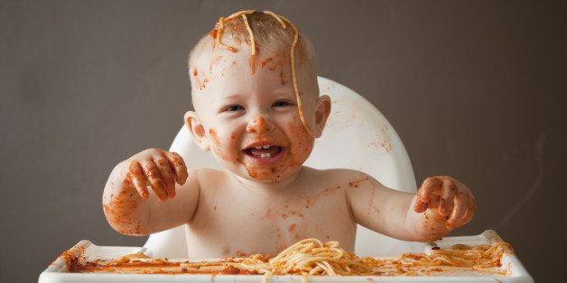 Baby covered in spaghetti