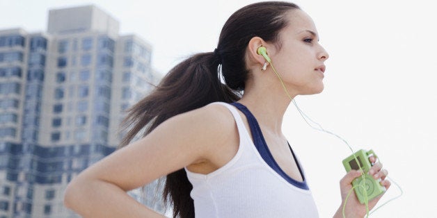 Mixed race woman jogging with mp3 player