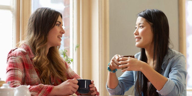 Two women talking together in cafe.