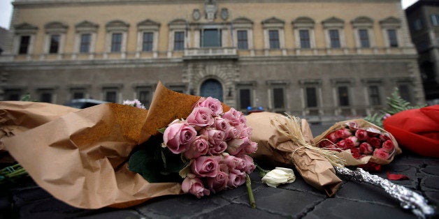 Flowers are laid in front of the French embassy in Rome, Saturday, Nov. 14, 2015. French police on Saturday hunted possible accomplices of eight assailants who terrorized Paris concert-goers, cafe diners and soccer fans with a coordinated string of suicide bombings and shootings in France's deadliest peacetime attacks. (AP Photo/Gregorio Borgia)