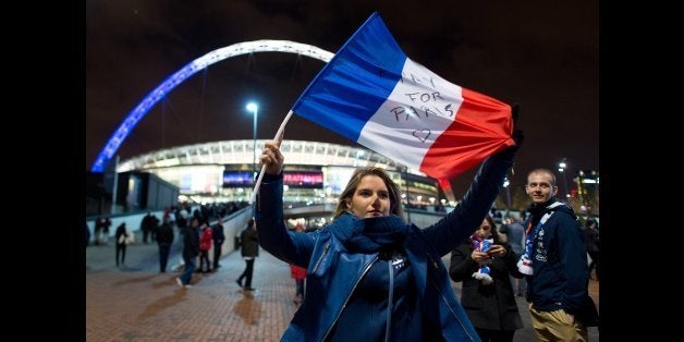 LONDON, ENGLAND - NOVEMBER 17: A french fan waves a french flag as she arrives ahead of tonight's International friendly match between England and France on November 17, 2015 in London, England. Security in London has tightened after a series of terror attacks across the French capital of Paris on Friday, leaving at least 129 people dead and hundreds more injured. (Photo by Ben Pruchnie/Getty Images)