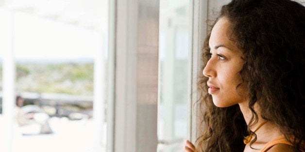 Woman daydreaming at window