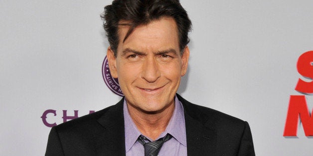 FILE - In this April 11, 2013 file photo, Charlie Sheen, a cast member in "Scary Movie V," poses at the Los Angeles premiere of the film at the Cinerama Dome in Los Angeles. Sheen was sued in Los Angeles Friday, Oct. 3, 2014, by a dental technician who claims the actor punched her in the chest and was abusive during an office visit in late September. (Photo by Chris Pizzello/Invision/AP, file)