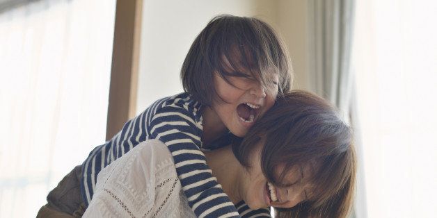 Mother giving daughter a piggyback ride,Girl of five years,Japan